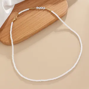 Chic white heishi polymer clay bead necklace with gold spacers and love letter charms.