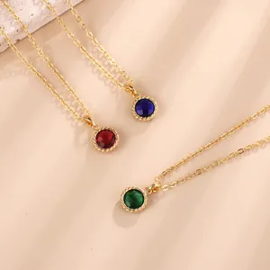 Detailed close-up view of elegant gold-plated birthstone necklaces featuring colorful zirconia charms.