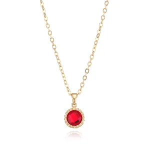 Gold-plated chain detail with a sparkling red cubic zirconia round pendant in twisted frame.
