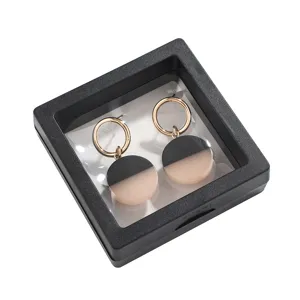 Geometric circle drop earrings featuring gold metal and contrast color design in display box