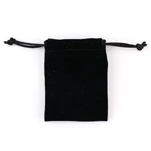 Black velvet jewelry pouch detail showing soft texture and drawstring design for small gifts.