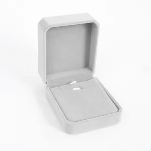 Grey velvet jewelry box detail showing soft interior lining and ring slot for elegant gift packaging.