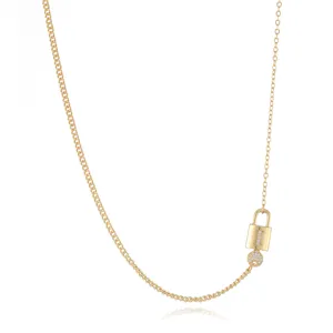 Gold lock and key pendant necklace detail, elegant fine chain accessory with zircons.