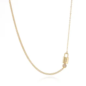 Detail view of gold-plated initial lock pendant necklace with sparkling zirconia stones.