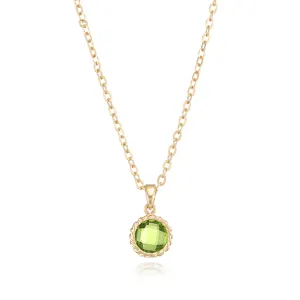 Close-up detail of the gold-plated green gemstone pendant necklace with fine chain.