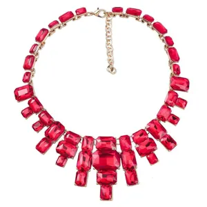 Statement red crystal rhinestone statement necklace with gold tone metal setting and adjustable chain.