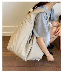 Japanese style casual large canvas tote bag, versatile slouchy shoulder bag for women daily commute.