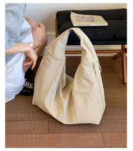 Close up of beige slouchy canvas tote bag texture, casual underarm shoulder bag lifestyle view.