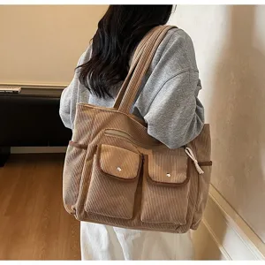 Corduroy multi-pocket shoulder tote bag with color-blocking design, practical handbag detail view.