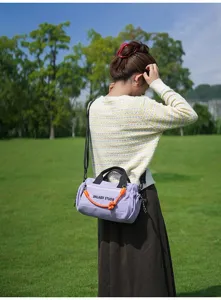Outdoor casual shoulder bag in light purple, detail shot showing stylish design and straps.