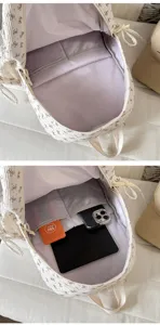 Corduroy bow backpack detail showing internal compartment and storage capacity for daily use.