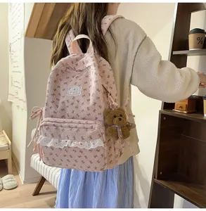Pink corduroy backpack with bow print and lace trim, lightweight casual student daypack.