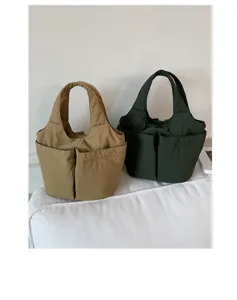 Detail shot of stylish nylon tote bags with multi-pockets, large capacity, and top handles.