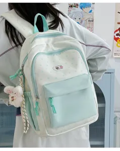 Cute star pattern canvas backpack featuring a front pocket and plush bunny for school use.