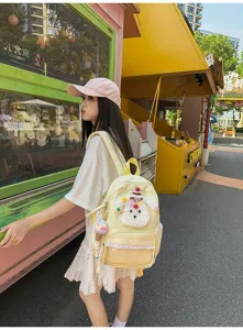 Sac à dos d'écolier chiot mignon avec bordure en dentelle et poche frontale transparente.