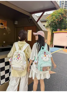 Joli sac à dos d'école pour chiot de dessin animé avec bordure en dentelle et poche transparente.