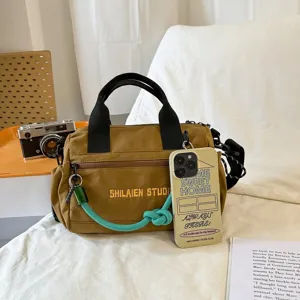 Canvas casual crossbody handbag with top handles, stylish multi-functional travel bag.