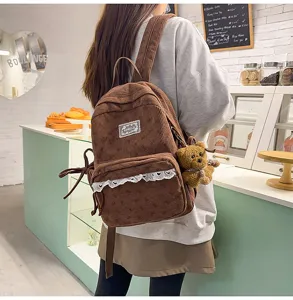 Korean style corduroy backpack with lace trim bow and cute bear pendant for student daily use.