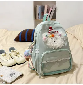Joli sac à dos vert menthe avec volants en dentelle, poche frontale transparente et peluche.