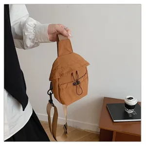 Chest sling bag detail view, casual outdoor brown crossbody backpack with adjustable strap.