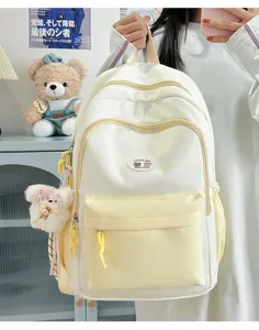Cute color-block canvas backpack for women, stylish student school bag with front pocket.
