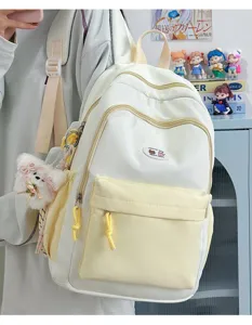 Cute color-block canvas backpack for students, featuring multiple compartments and a plush pendant.