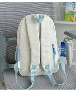Detail view of cute white backpack with light blue stars, adjustable straps and side zipper.