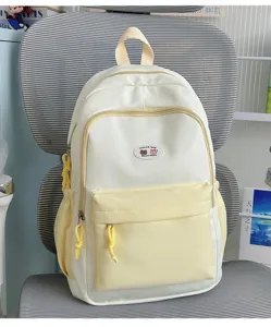 Detail shot of white yellow color-block backpack with cute star pattern and front pocket.