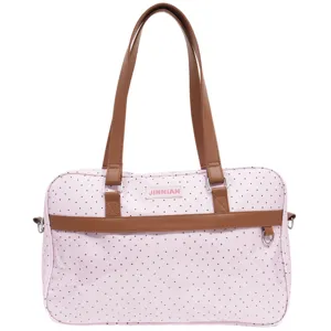 Vista dettagliata della borsa a pois rosa, che mostra i manici marroni e la qualità.
