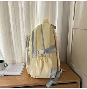 Side view of stylish yellow canvas backpack featuring adjustable straps and deep side pockets.