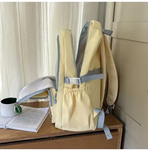 Detail shot of a stylish yellow and blue student backpack with multi-pockets and secure buckles.