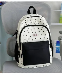 Cute star pattern canvas backpack detailed view, black and white color block school bag design.