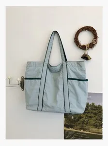 Casual light blue nylon tote bag, large capacity shoulder bag for daily commute and school.