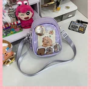 Detail view of the light purple ita bag with clear PVC pocket, showcasing cute pins and cards.