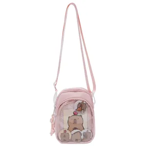 Pink canvas crossbody ita bag with clear front pocket for anime badges and daily use.