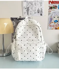 Sac à dos à pois style ins japonais pour femmes, sac d'école blanc mignon avec poche avant.