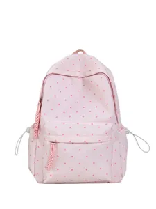 Gros plan sur les détails de la poche du sac à dos rose et de ses curseurs tressés.