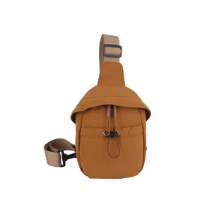 Close-up detail of casual outdoor brown chest bag, lightweight sling design, adjustable strap.
