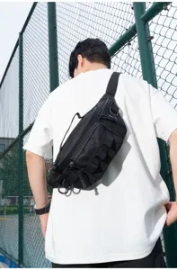 Close-up view of the black tactical chest bag worn outdoors, showing multiple pockets and durable straps.