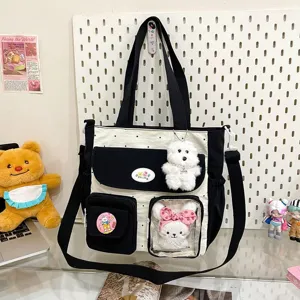 Detailed shot of the cute polka dot canvas tote bag with multiple pockets and plush dolls.