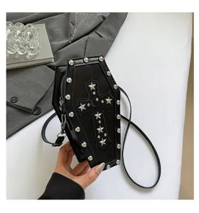 Close-up detail of gothic dark style coffin cross-body bag with silver studs and star motif.