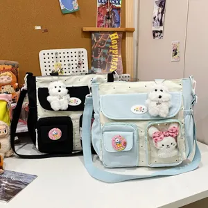 Cute canvas crossbody bag with plush dog pendant, large capacity multi-pocket student satchel.