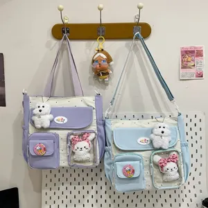 Detail shot of cute canvas tote bag with polka dot pattern, multi-pocket design and plush toys.