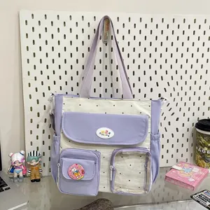 Detailed view of the cute polka dot canvas tote bag with multiple pockets and purple contrast.