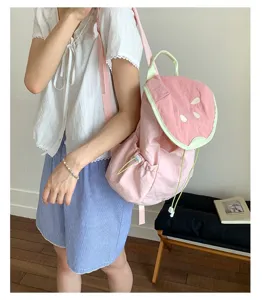 Close-up detail of the cute watermelon style student backpack with sweet pink and green design.