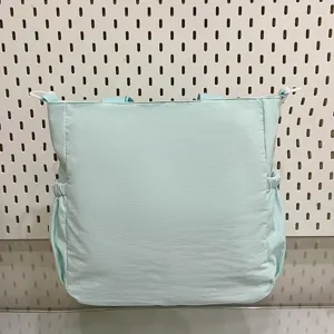 Light green large capacity shoulder bag detail view, side pocket design, casual daily handbag.
