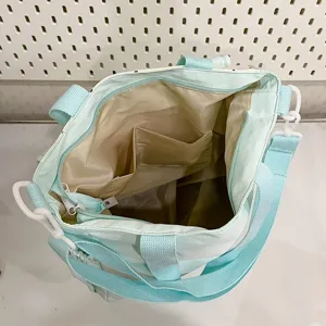 Cute polka dot canvas shoulder bag interior detail showing spacious compartment and pockets.