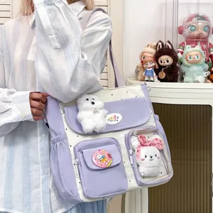 Cute polka dot canvas shoulder bag with large capacity and multi-pocket design detail.