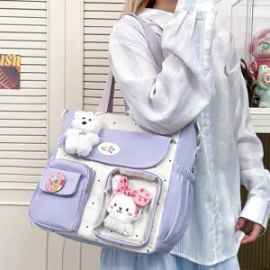 Cute polka dot canvas shoulder bag with transparent front pocket and cute plush charms.