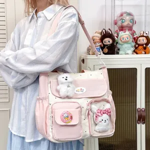 Cute polka dot shoulder bag with large capacity, multi-pocket design, and plush charms.
